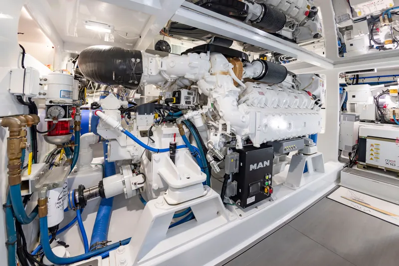 Slide: The Image of The engine room of a 2022 Scarborough 63 features a MAN engine and complex piping. - 14