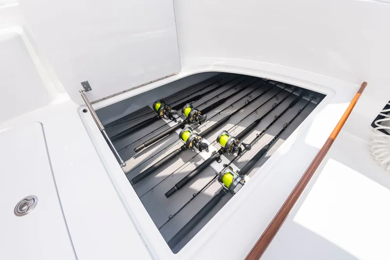 Slide: The Image of Fishing rods are neatly stored in a dedicated compartment on a boat. - 37