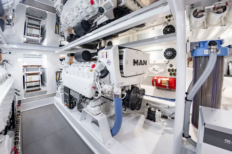 Slide: The Image of The engine room of a 2022 Scarborough 63 boat features a MAN engine and various technical components. - 26