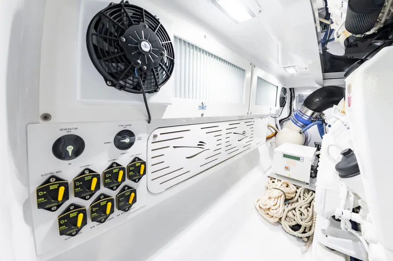 Slide: The Image of The engine room of a 2022 Scarborough 63 features switches, a fan, and ropes. - 27