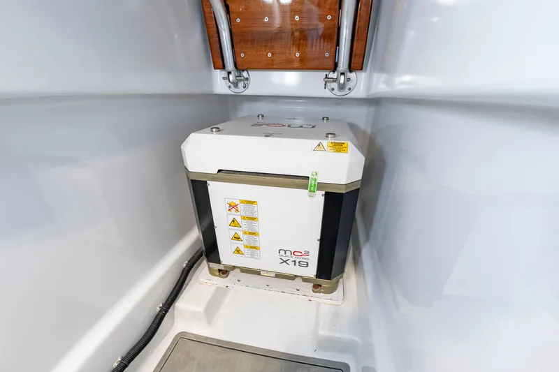 Slide: The Image of A white generator is installed in a clean, white engine room. - 19