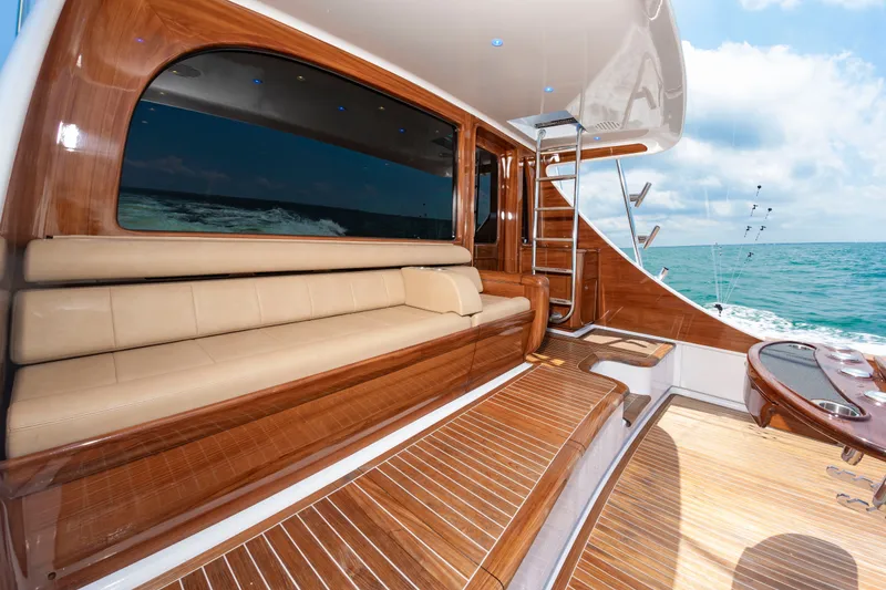 Slide: The Image of Luxurious boat with sleek wooden flooring, beige sofa, and stairs. It sails on open sea. - 44
