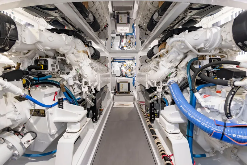 Slide: The Image of The engine room of a 2022 Scarborough 63 boat features two large engines and complex wiring. - 15