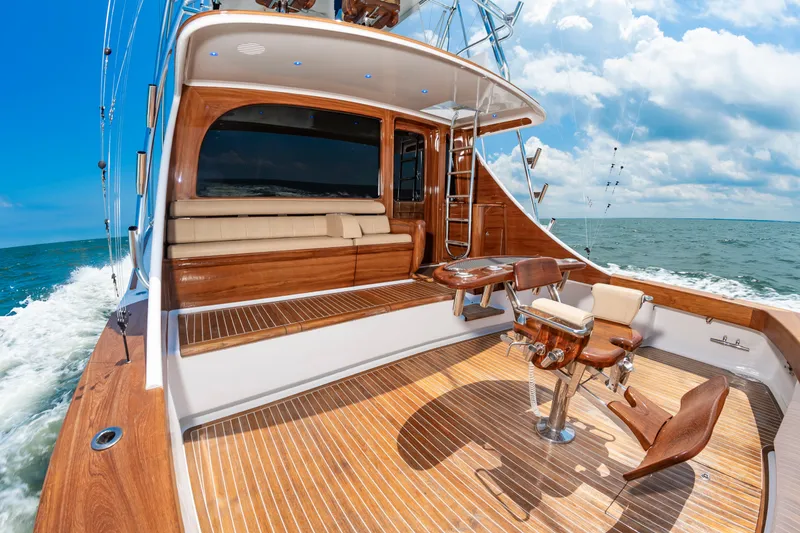 Slide: The Image of The image shows the deck of a 2022 Scarborough 63 yacht with elegant wood flooring and comfortable seating. - 42