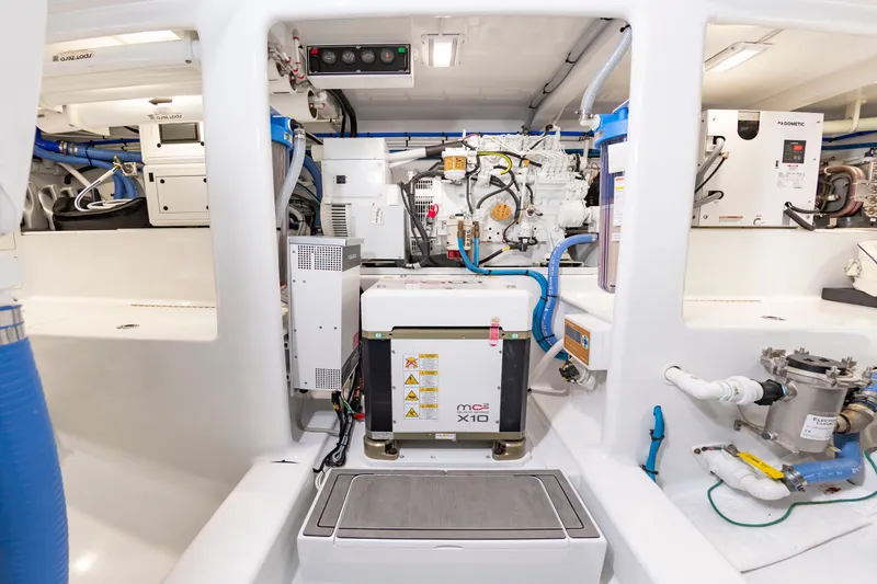 Slide: The Image of The engine room of a 2022 Scarborough 63 features modern equipment and wiring. - 20