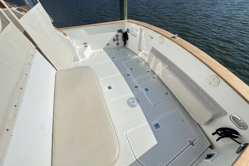 Slide: The Image of Spacious deck of 2002 Legacy Express boat with seating and storage compartments. - 68