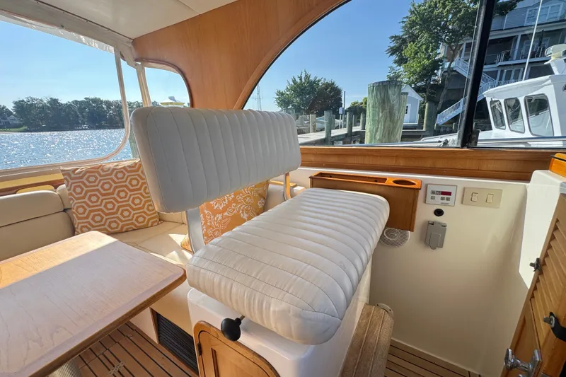 Slide: The Image of Interior of 2002 Legacy Express boat with plush seating and scenic water view. - 46