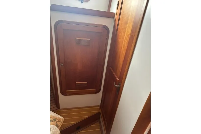 Slide: The Image of Wooden interior of 2002 Legacy Express boat, featuring a door and paneling. - 20