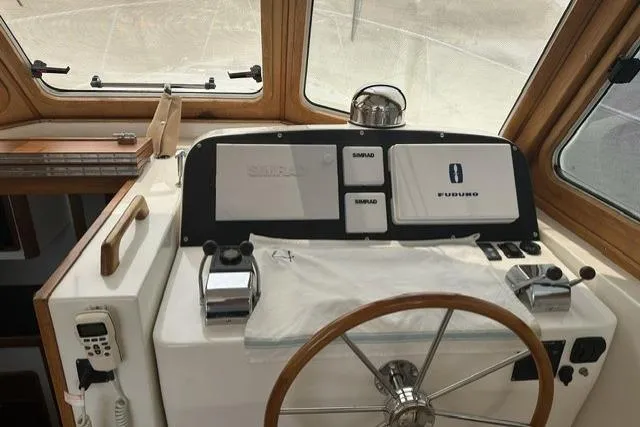 Slide: The Image of Helm of 2002 Legacy Express boat with navigation equipment and wooden steering wheel. - 8