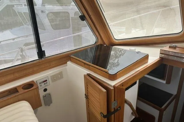 Slide: The Image of Interior of a 2002 Legacy Express boat with wooden cabinetry and windows. - 11