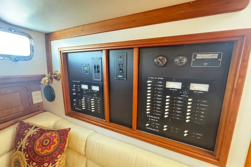 Slide: The Image of Electrical control panel in a 2002 Legacy Express boat interior, featuring gauges and switches. - 48
