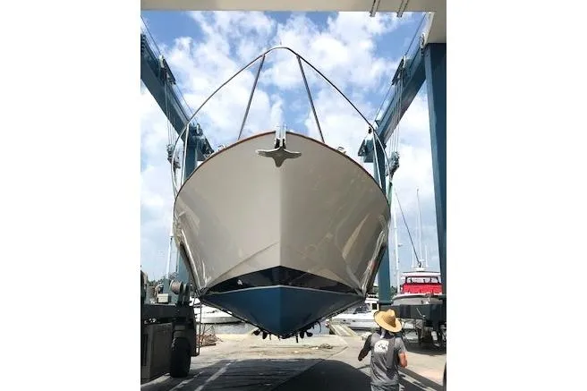 Slide: The Image of 2002 Legacy Express boat in dry dock, viewed from the front under a clear sky. - 1