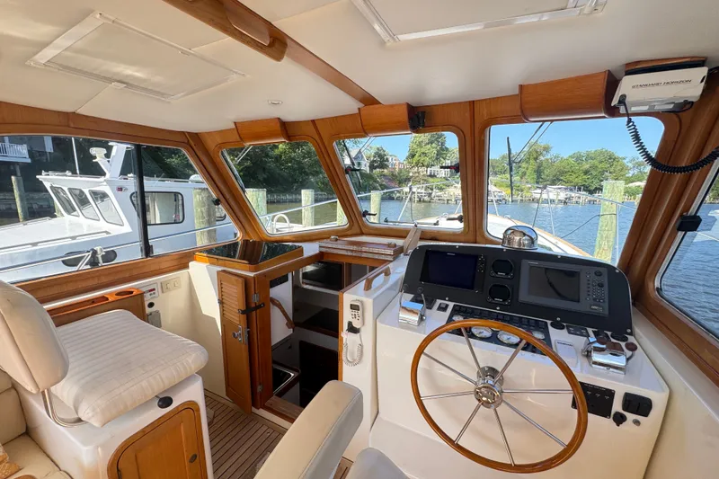 Slide: The Image of Interior of a 2002 Legacy Express boat with wooden accents and modern navigation equipment. - 41