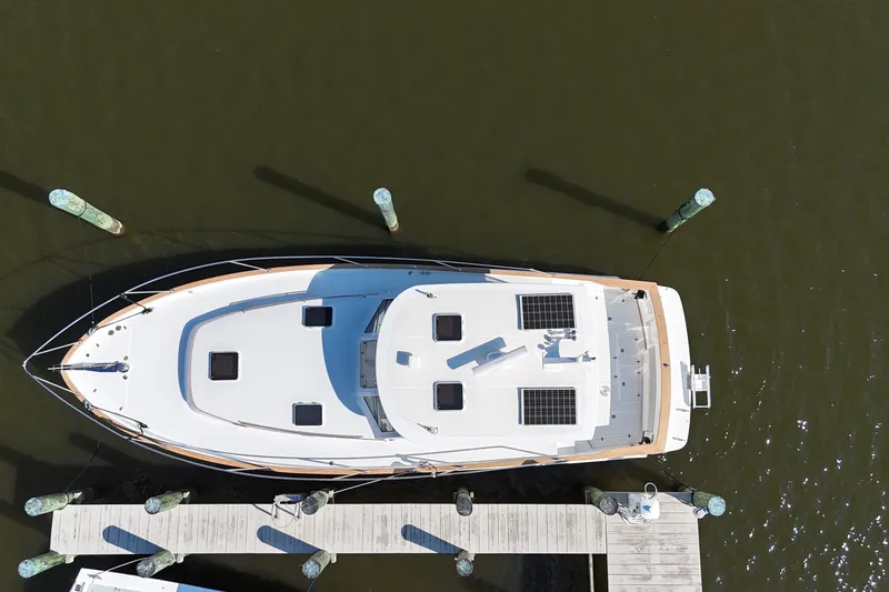 Slide: The Image of Aerial view of 2002 Legacy Express yacht docked at a marina. - 29
