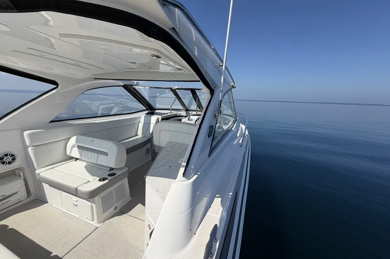 Slide: The Image of 2021 Regal 35 Sport Coupe interior with sleek seating on calm water. - 13