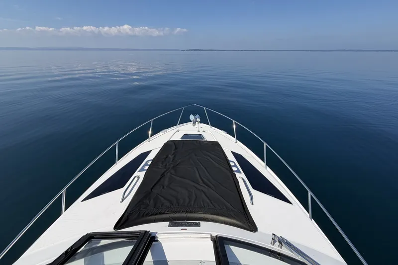 Slide: The Image of Bow view of 2021 Regal 35 Sport Coupe on calm water. - 21