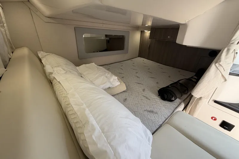 Slide: The Image of Interior cabin of 2021 Regal 35 Sport Coupe with bed and pillows. - 31