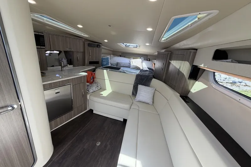 Slide: The Image of Interior of 2021 Regal 35 Sport Coupe, featuring modern kitchen and cozy seating area. - 25