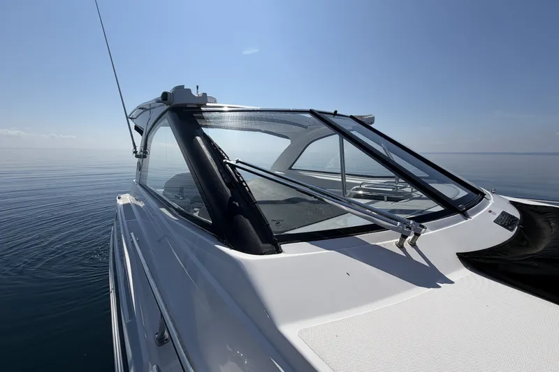 Slide: The Image of 2021 Regal 35 Sport Coupe cruising on calm waters under clear skies. - 18