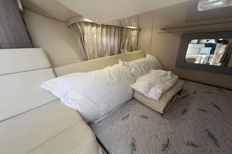 Slide: The Image of Interior cabin of 2021 Regal 35 Sport Coupe with bed and pillows. - 32