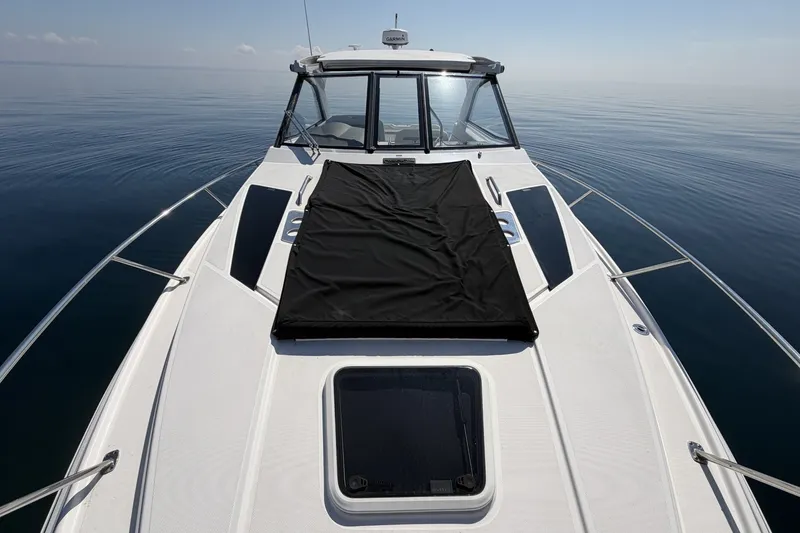 Slide: The Image of 2021 Regal 35 Sport Coupe on calm water, showcasing sleek deck design. - 22
