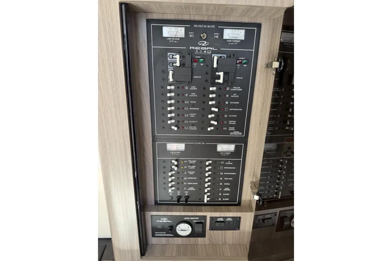 Slide: The Image of Electrical control panel of a 2021 Regal 35 Sport Coupe boat, featuring switches and gauges. - 36