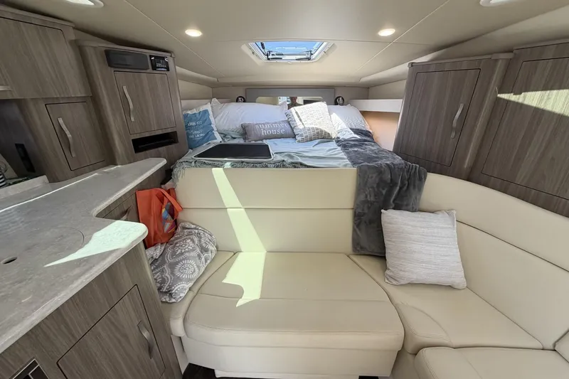 Slide: The Image of Interior of 2021 Regal 35 Sport Coupe with cozy seating and bed area. - 27