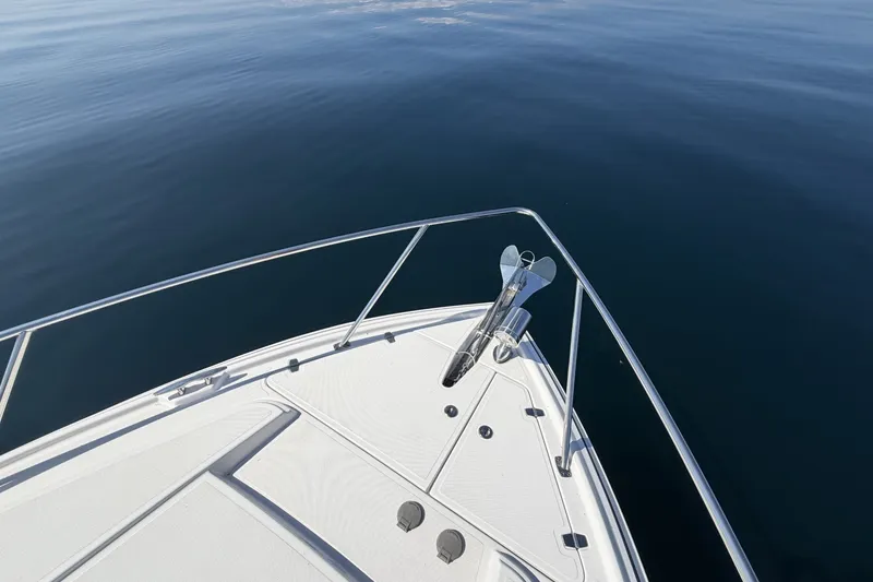 Slide: The Image of Bow of 2021 Regal 35 Sport Coupe on calm water. - 23