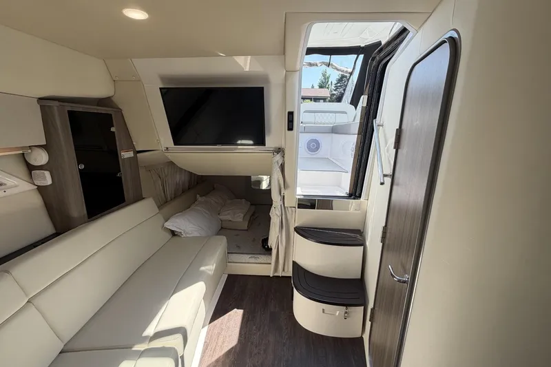 Slide: The Image of Interior of 2021 Regal 35 Sport Coupe, featuring modern seating and entertainment area. - 28
