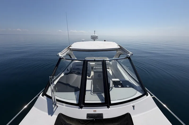 Slide: The Image of 2021 Regal 35 Sport Coupe cruising on calm, open water under clear skies. - 19