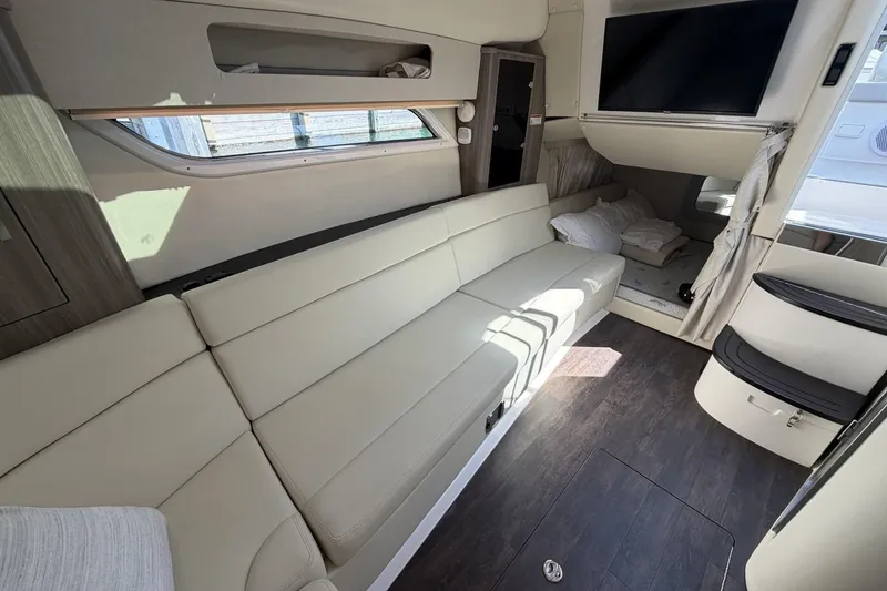 Slide: The Image of Interior of 2021 Regal 35 Sport Coupe with beige seating and modern amenities. - 29