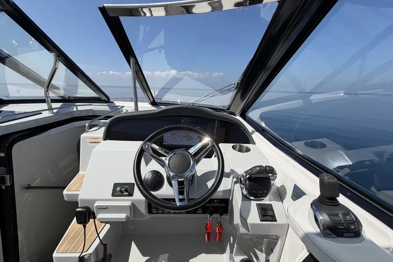 Slide: The Image of Cockpit of 2021 Regal 35 Sport Coupe with steering wheel and navigation controls. - 17