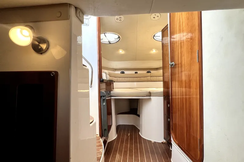 Slide: The Image of Interior of 2004 Century 3200 Walk-Around boat with cozy seating and wooden accents. - 113