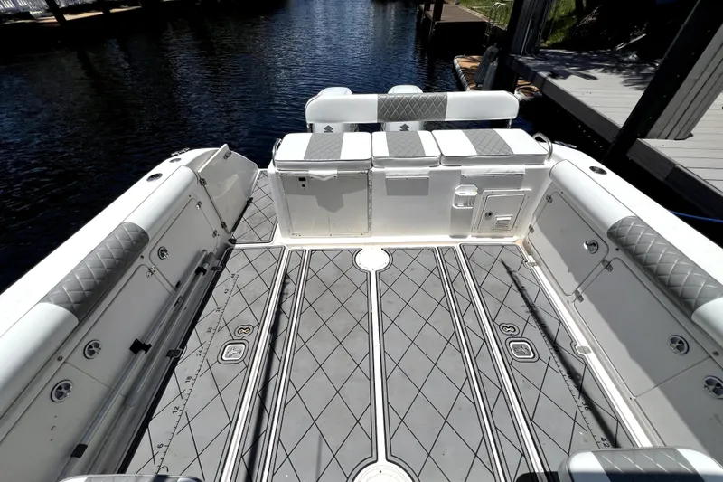 Slide: The Image of 2004 Century 3200 Walk-Around boat interior with cushioned seating and patterned flooring. - 58
