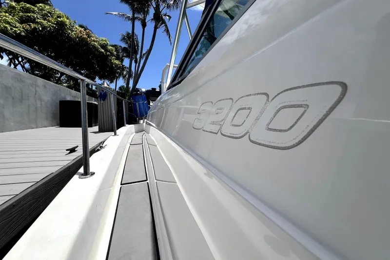 Slide: The Image of 2004 Century 3200 Walk-Around boat docked under clear blue sky. - 117