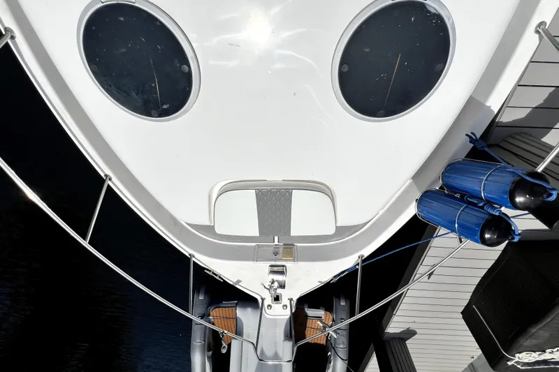 Slide: The Image of Top view of a 2004 Century 3200 Walk-Around boat docked with blue fenders. - 49
