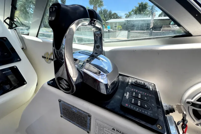 Slide: The Image of Close-up of 2004 Century 3200 Walk-Around boat controls, featuring throttle and trim tabs. - 93