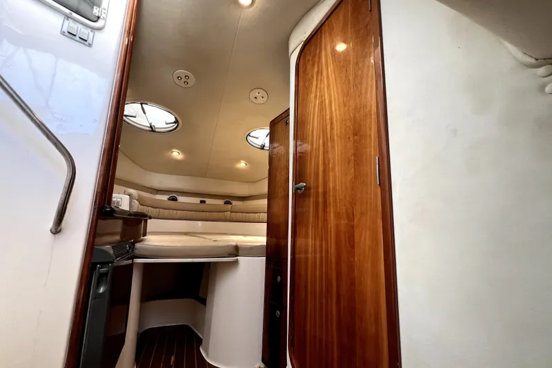 Slide: The Image of Interior of 2004 Century 3200 Walk-Around boat with wood accents and cozy seating area. - 111