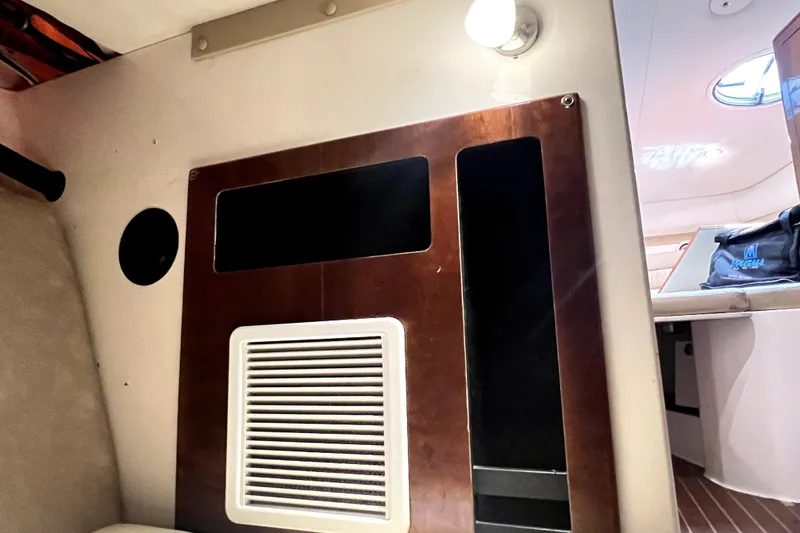 Slide: The Image of Interior view of a 2004 Century 3200 Walk-Around boat cabin with wooden paneling. - 101
