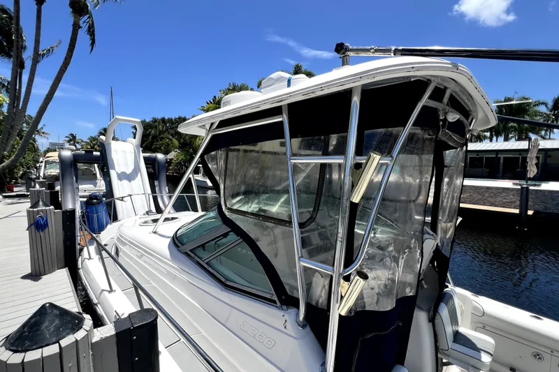 Slide: The Image of 2004 Century 3200 Walk-Around boat docked under clear blue sky. - 30