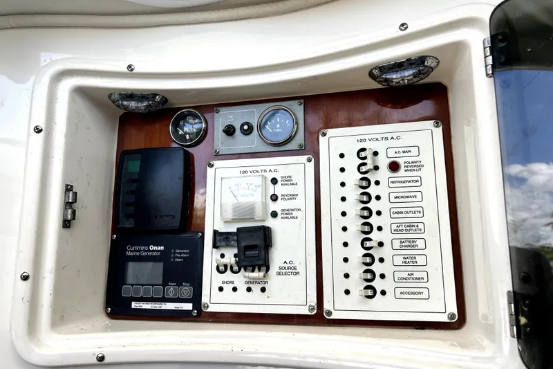 Slide: The Image of Control panel of a 2004 Century 3200 Walk-Around boat with various switches and gauges. - 64