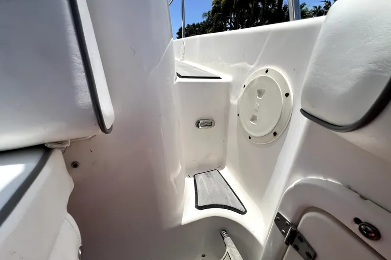 Slide: The Image of Interior view of a 2004 Century 3200 Walk-Around boat, featuring seating and storage. - 116