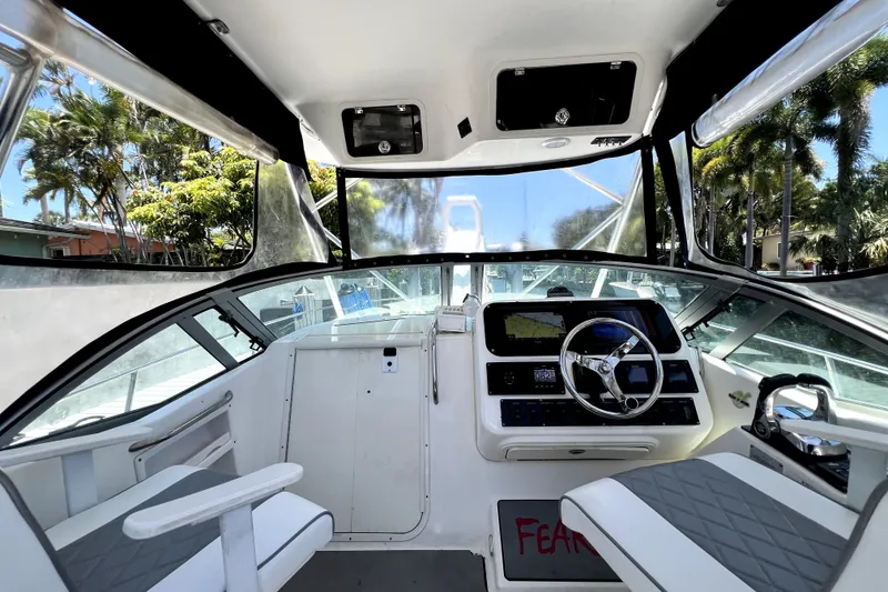 Slide: The Image of Interior view of a 2004 Century 3200 Walk-Around boat cockpit with steering wheel and seating. - 61