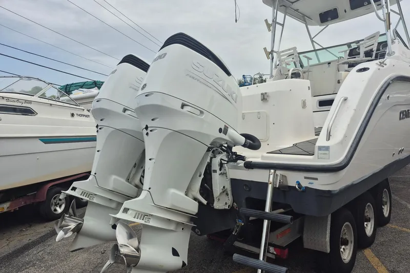 Slide: The Image of 2004 Century 3200 Walk-Around boat with dual Suzuki outboard motors on a trailer. - 3