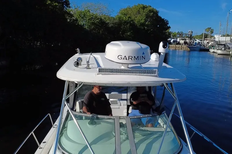 Slide: The Image of 2004 Century 3200 Walk-Around boat with Garmin equipment on a calm waterway. - 14