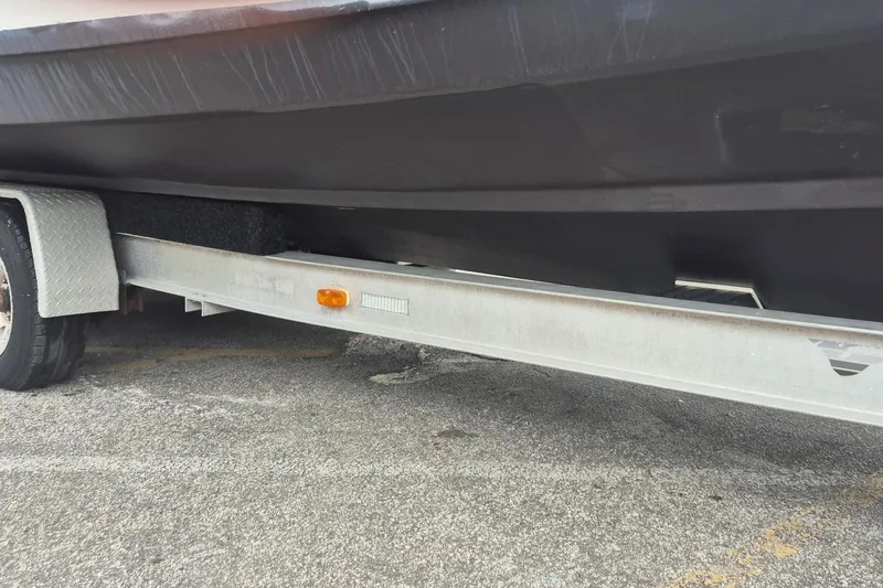 Slide: The Image of A boat on a trailer with a black hull and an orange reflector. - 2