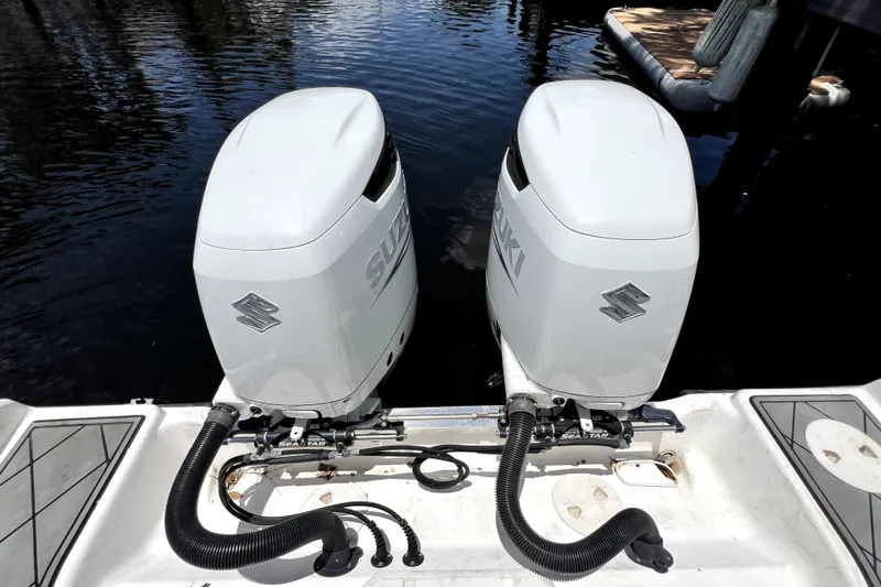 Slide: The Image of Twin Suzuki outboard motors on a 2004 Century 3200 Walk-Around boat. - 82