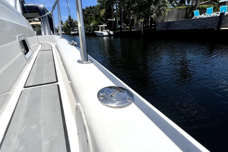 Slide: The Image of 2004 Century 3200 Walk-Around boat docked by a serene waterfront. - 71