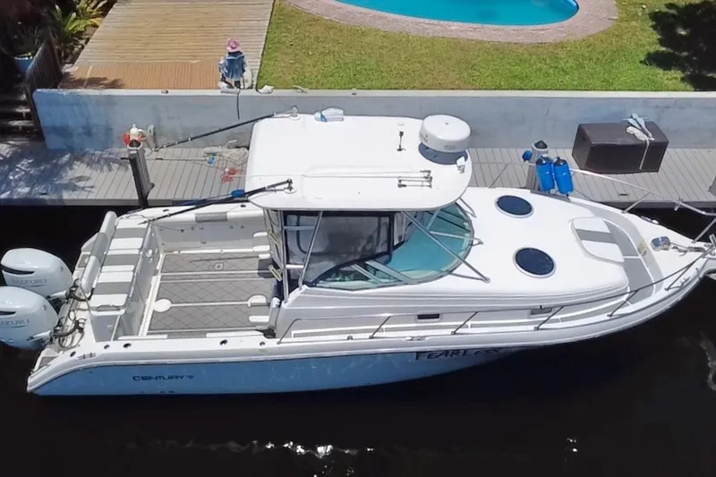 Slide: The Image of 2004 Century 3200 Walk-Around boat docked near a pool, aerial view. - 21