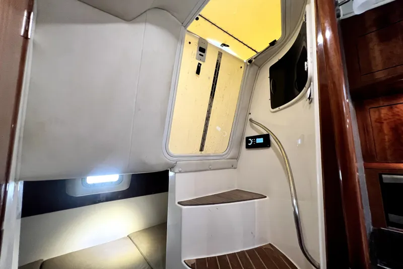 Slide: The Image of Interior cabin of a 2004 Century 3200 Walk-Around boat with stairs and wood accents. - 66